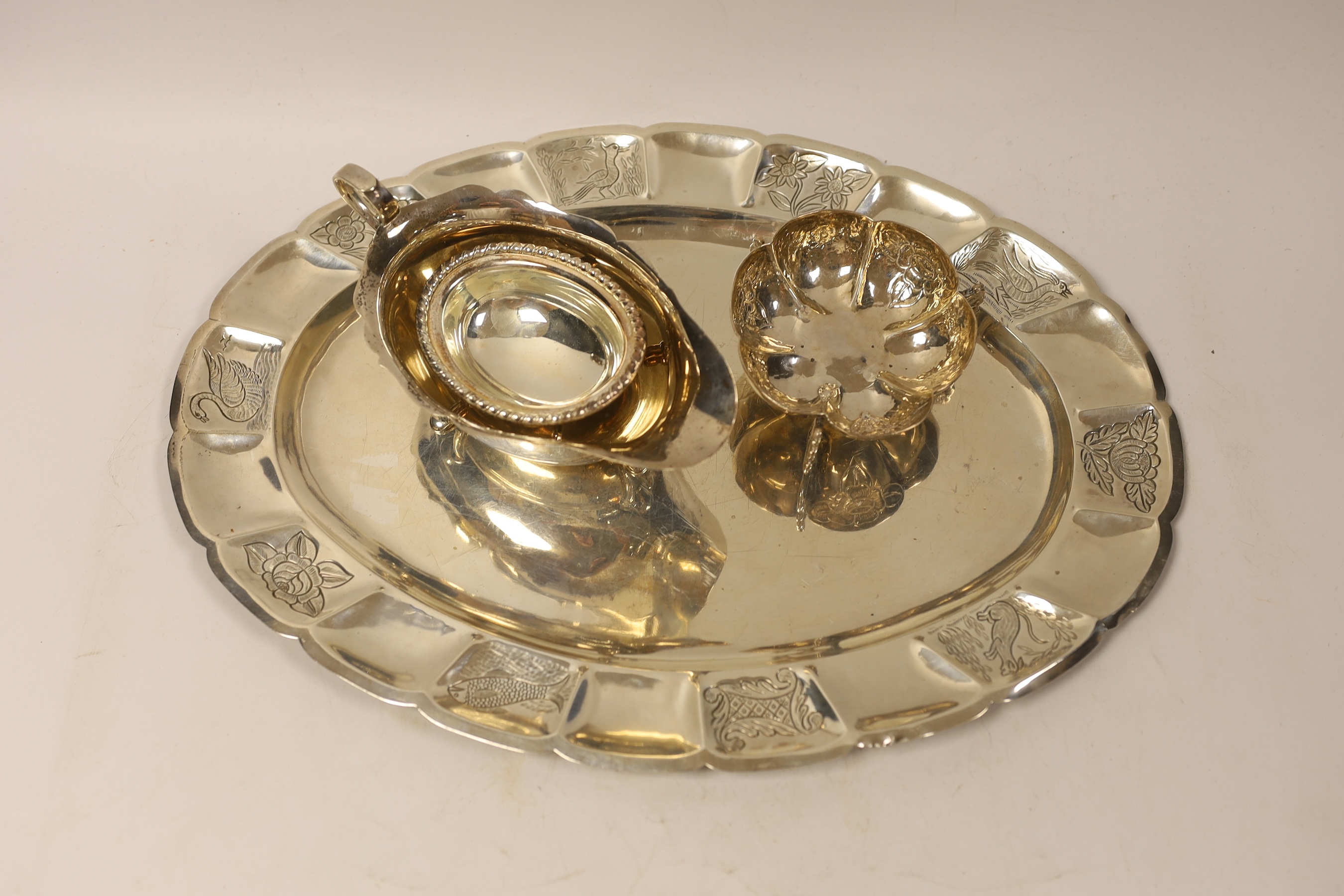 A Mexican sterling oval tray, 40.1cm, a similar bowl on tripod supports, a modern silver sauce boat and oval silver salt, 32.7oz.
